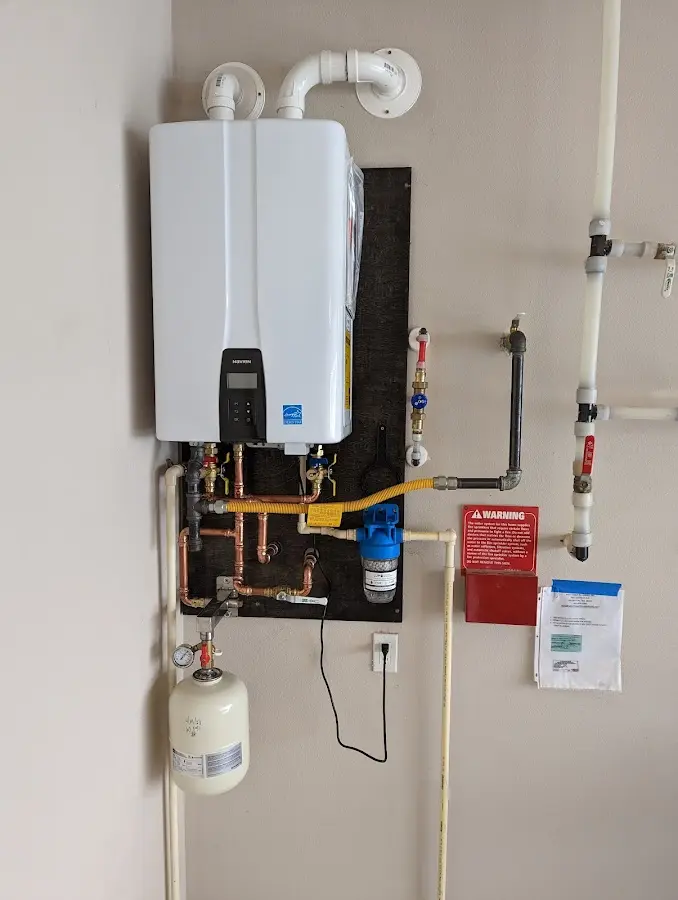 Professional plumber installing copper piping in a Monmouth Beach home